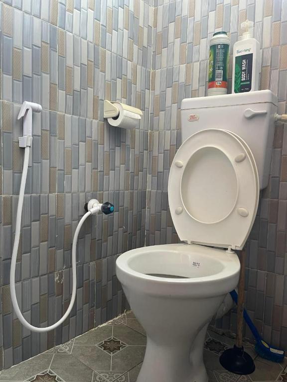 a bathroom with a white toilet in a stall at New Barcelona in Mombasa