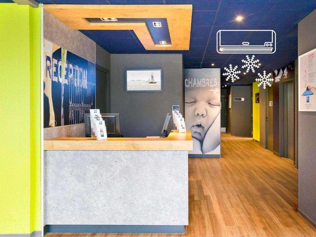 a lobby of a store with a reception counter at Ibis Budget Saint Malo Centre in Saint Malo