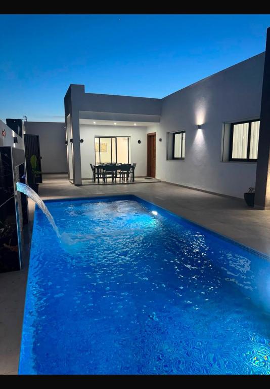 a large blue swimming pool in a house at Villa Tanit in Taguermess