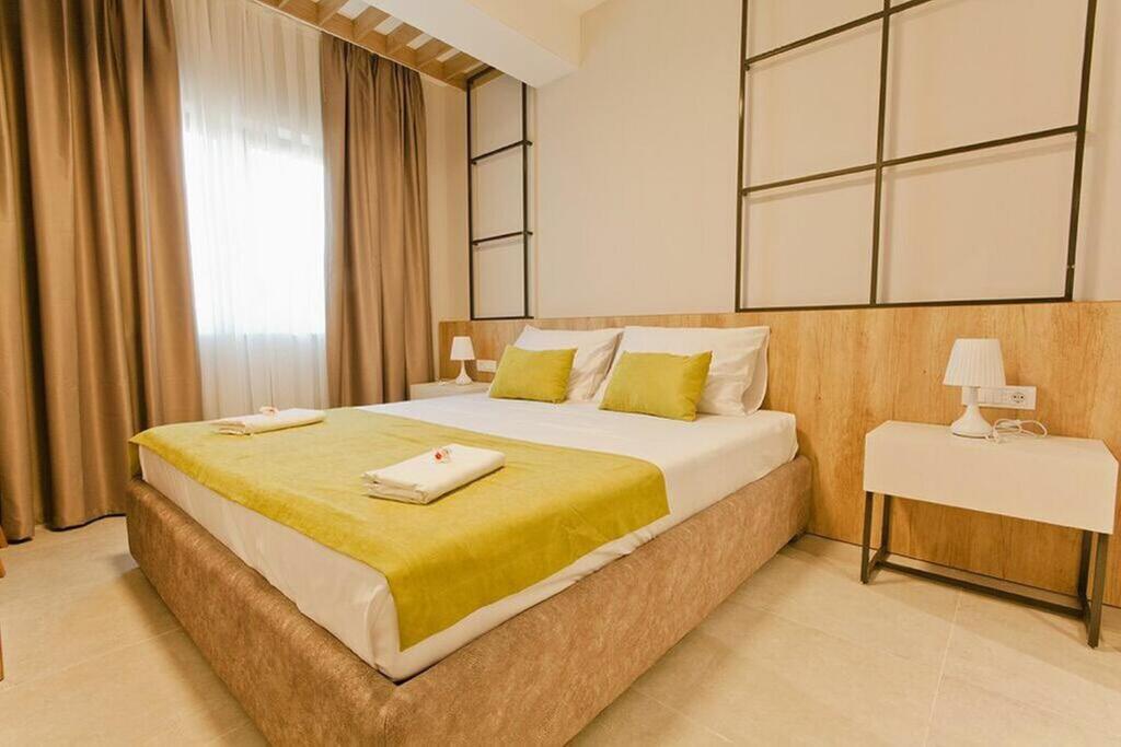 a bedroom with a large bed and a window at Hotel Hills in Donji Štoj