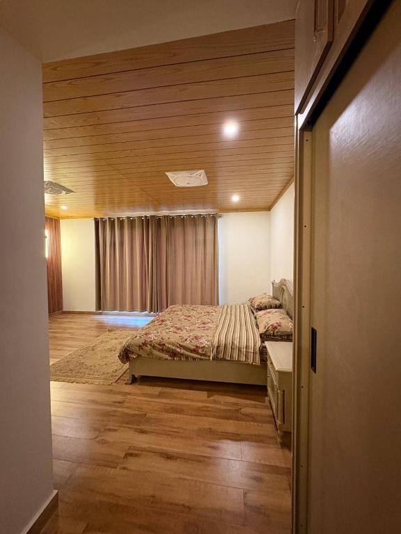 a bedroom with a bed in a room at The Elysian Villa in Bhurban
