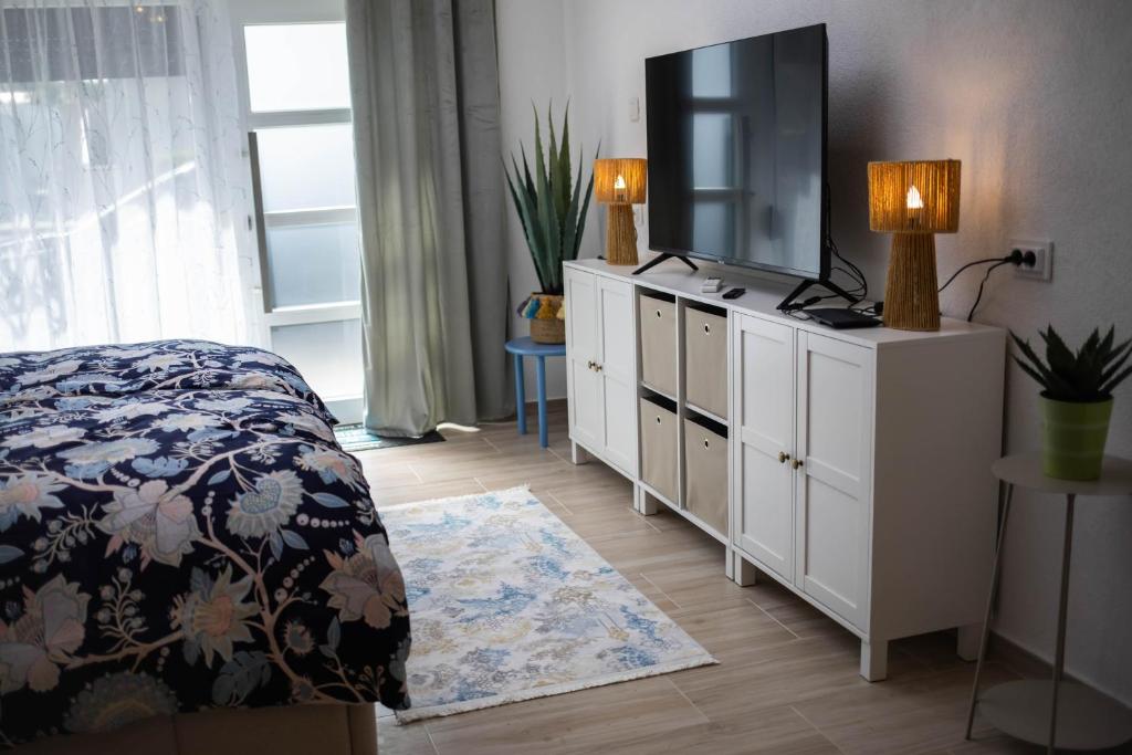 a bedroom with a bed and a television on a dresser at Apartman NOA in Novska