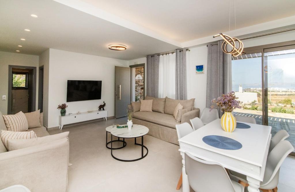 a living room with a couch and a table at Aegean Whispers in Agios Fokas