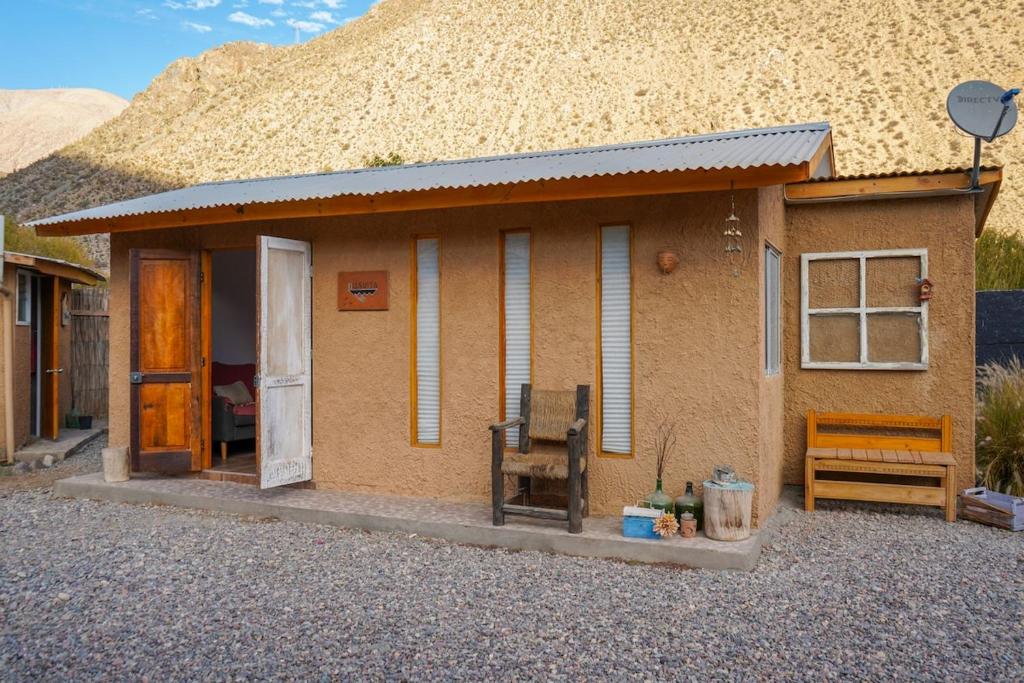 a small house in front of a mountain at Río Luna cabaña 2 in Diaguita