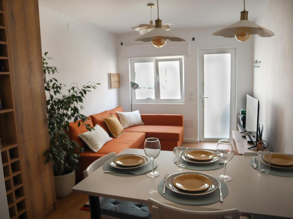 a living room with a table with wine glasses at Casa 4 Peixes in Leiria