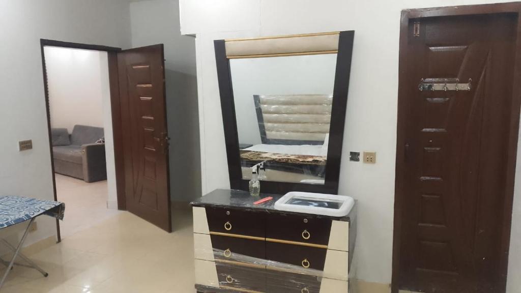 a bathroom with a sink and a mirror at Galyat Apartments in Abbottabad