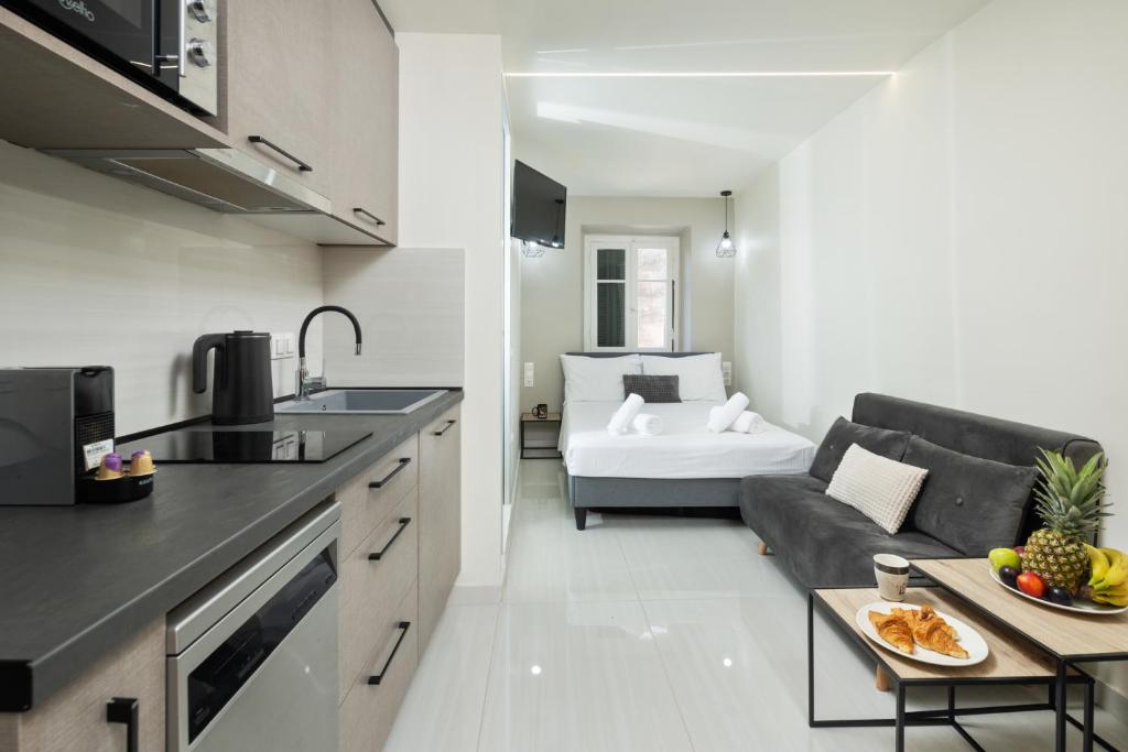 a kitchen and a living room with a couch at Casa Petridou 2 in Corfu