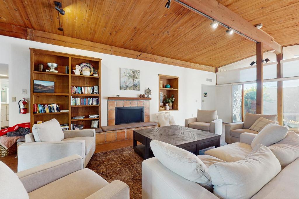 a living room with white furniture and a fireplace at Poolside Oasis! Phoenix Group Sanctuary w/ Patio in Phoenix