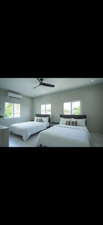 a bedroom with two beds and a ceiling fan at Teika comfort in Kingston