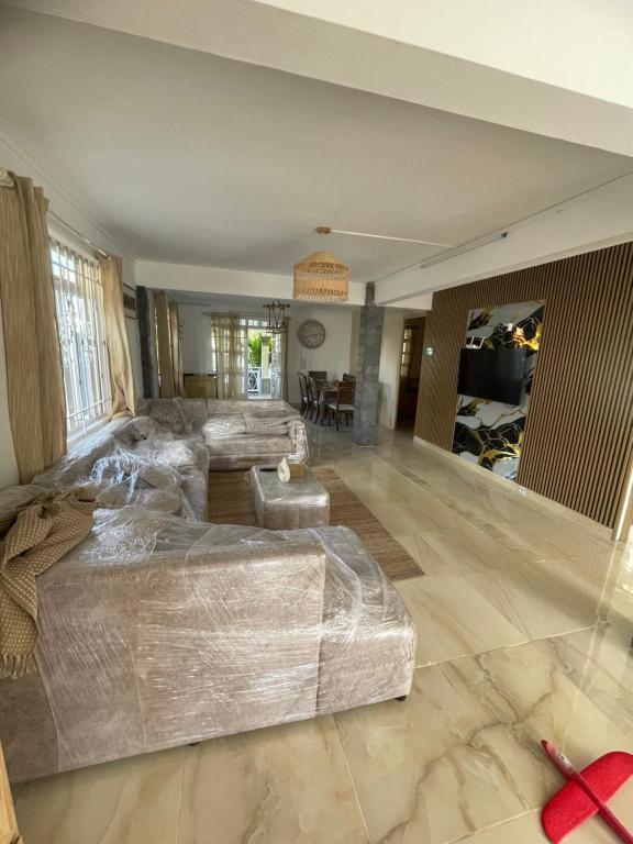 a large living room with a couch and a table at Casa Lotus in Pereybere