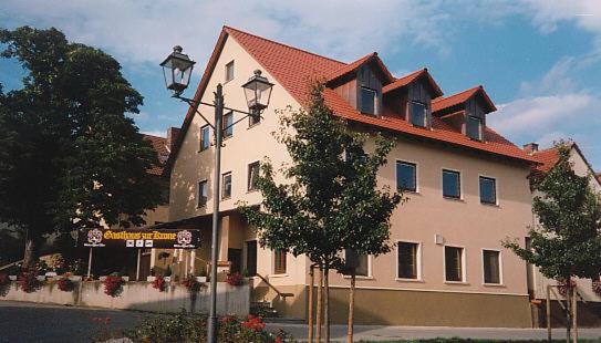 a large white building with a red roof at Hotel Gasthaus zur Krone in Gochsheim