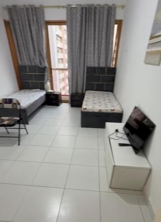 a living room with two couches and a table at Alreem building in Abu Dhabi