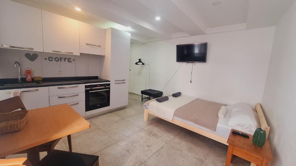 a small bedroom with a bed and a kitchen at Basel city in Basel