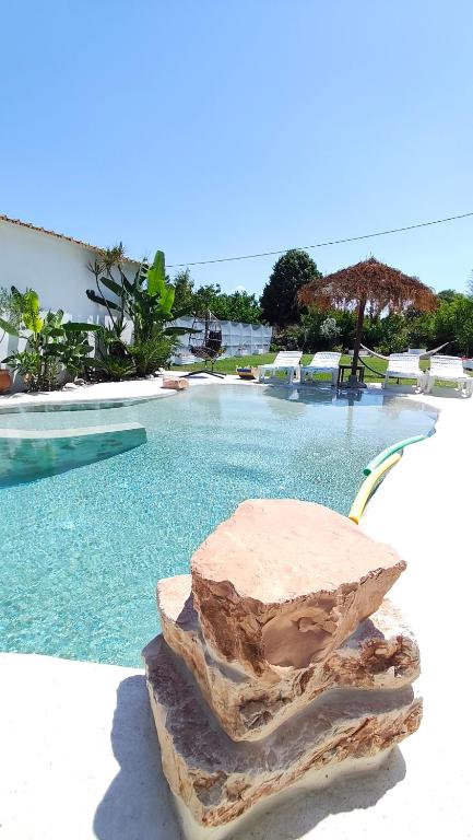 a rock sitting next to a swimming pool at Villa Aura, Kanalia Corfu in Corfu
