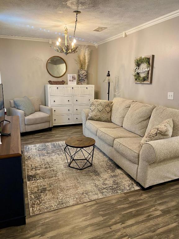 a living room with a couch and a table at Lucky 13 Condo in Starkville