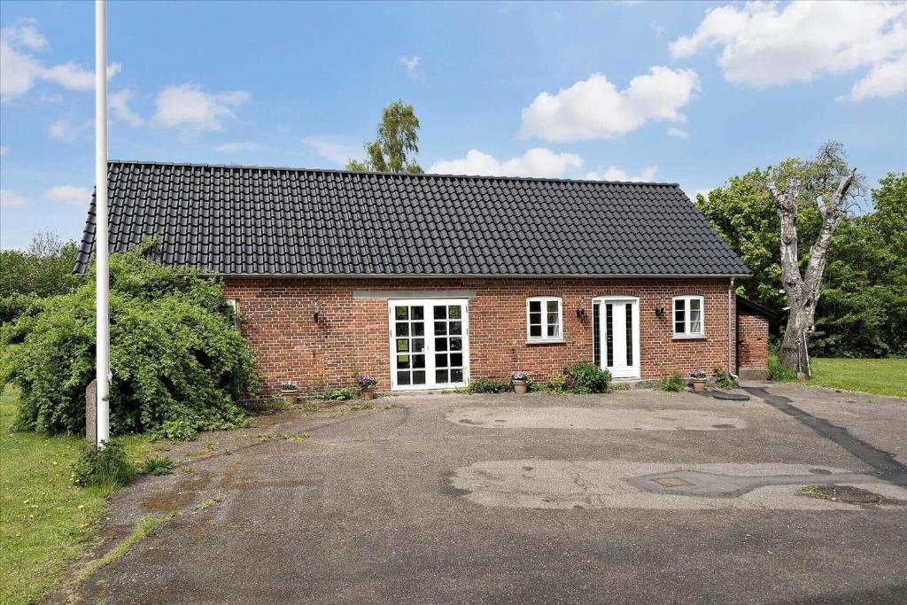 a red brick house with a white door at FA028-Karise-Tagerupvej-29 in Karise
