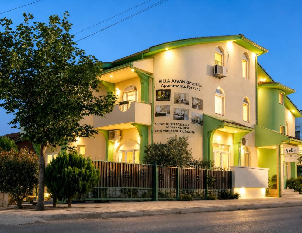 a building with a tree in front of it at Villa Jovan Gevgelija in Gevgelija