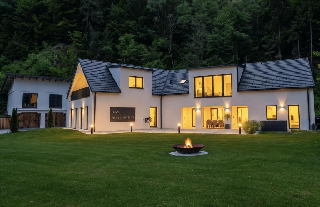 a house with a fire pit in the yard at Das Freyenstein in Berghof