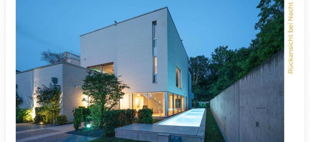 a large white building with a large window at ThehiddenLakehouse Pool Sauna Whirlpool in Duisburg