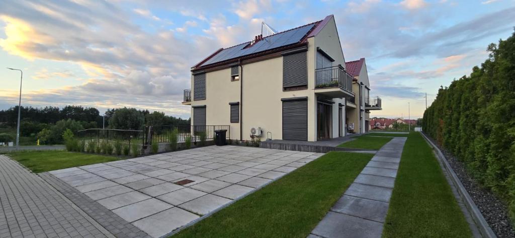 a house with a lawn in front of it at Villa nad stawem in Pszczew