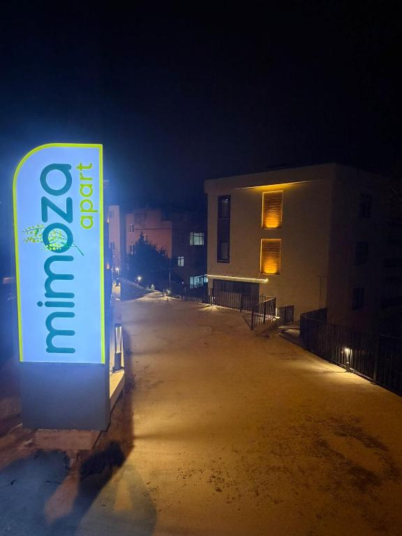 a sign is lit up on a street at night at Mimoza Apart in Trabzon
