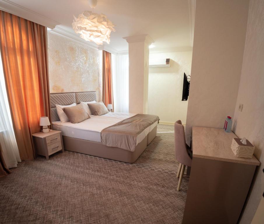 a hotel room with a bed and a window at Gala Terrace Hotel & Restaurant in Baku