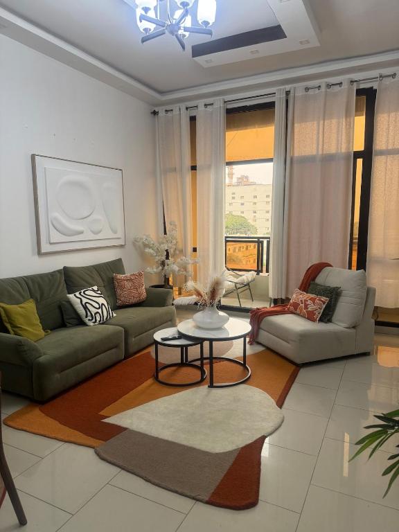 a living room with a couch and a table at Premium apartment with balcony in La Gombe in Kinshasa