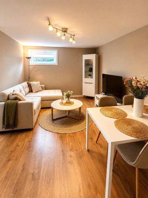 a living room with a couch and a table at Leilighet Preikestolen in Strand