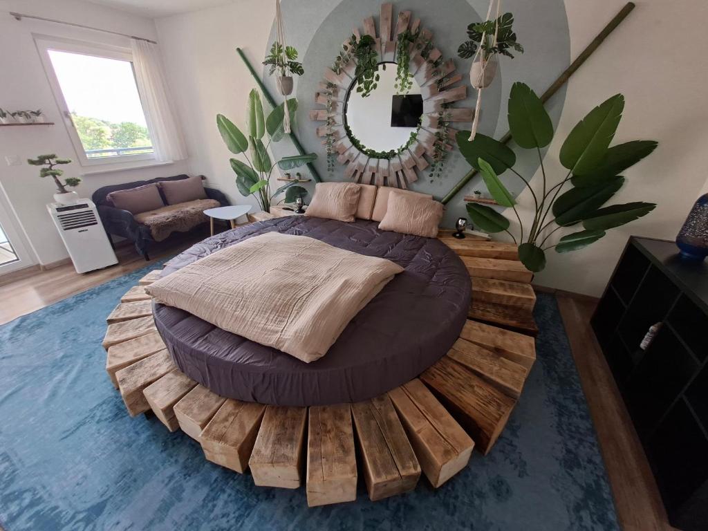 a bedroom with a large bed on a wooden platform at Jungle Dream in Hitzkirch