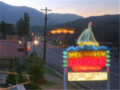 a neon sign for a motel rover on a highway at Mel Haven Motel in Colorado Springs