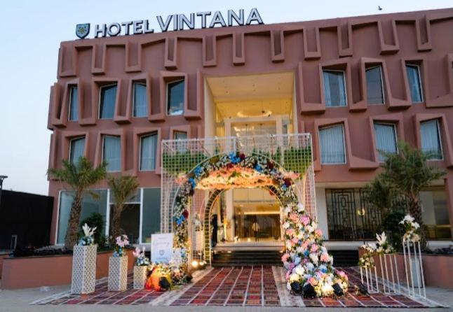 a hotel with an arch in front of a building at Hotel Vintana in Nananpur