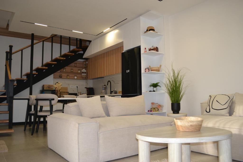 a living room with a white couch and a table at Vila 18 in Velipojë