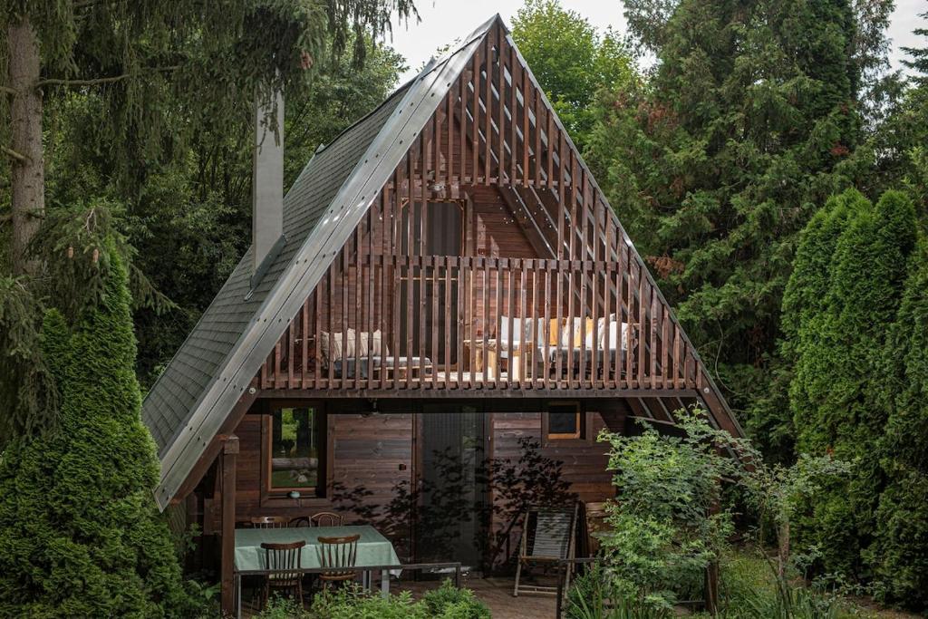 a large wooden house with a gambrel roof at MOHA guesthouse in Szokolya