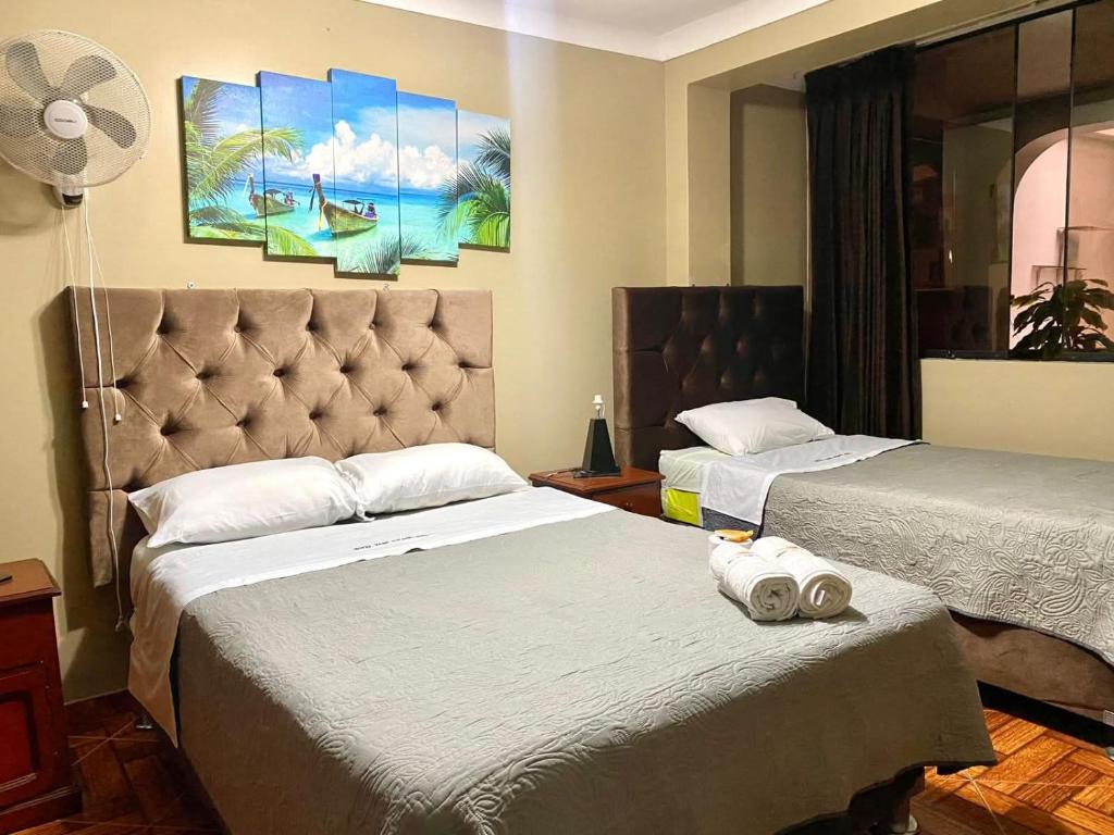 a bedroom with two beds and a headboard at Hotel continental in Urbanizacion Buenos Aires