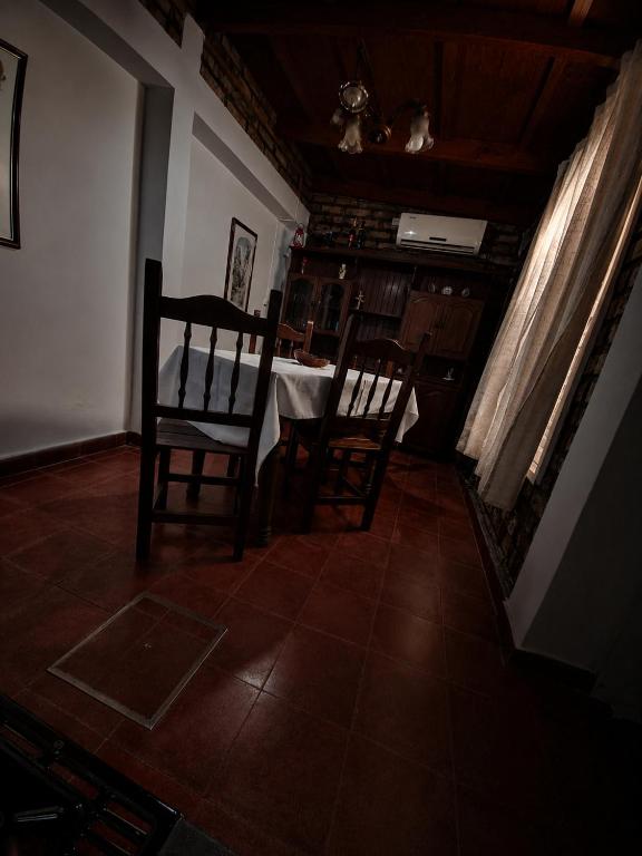 a dining room with two chairs and a table at Olloqui Dpto in Villa Mercedes