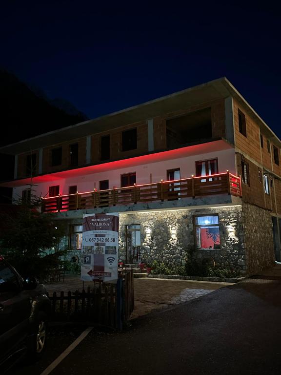 a building with a sign in front of it at Guesthouse Dritan Selimaj in Valbonë