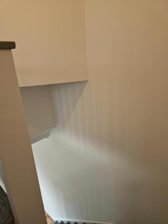 an empty closet with white walls and ceilings at Chilux in Rainham
