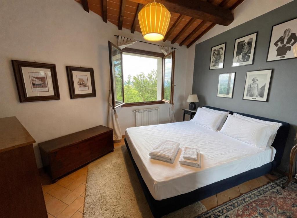 a bedroom with a bed with two books on it at Mugello View in Bovecchio