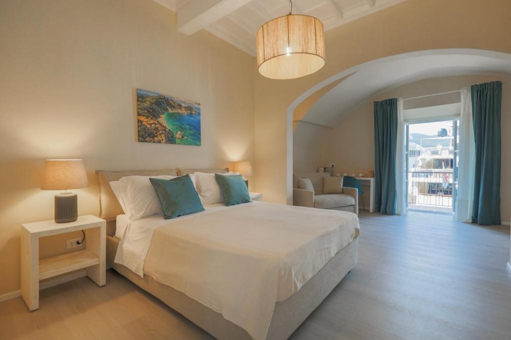 a bedroom with a bed and a table and a chair at King Rooms in Portoferraio