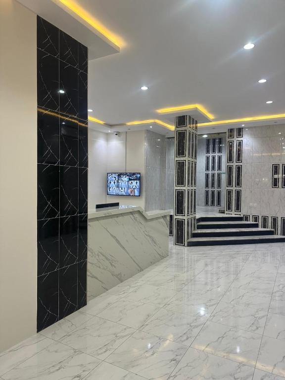 a lobby with a television and a marble floor at جوهرة عسير in Abha