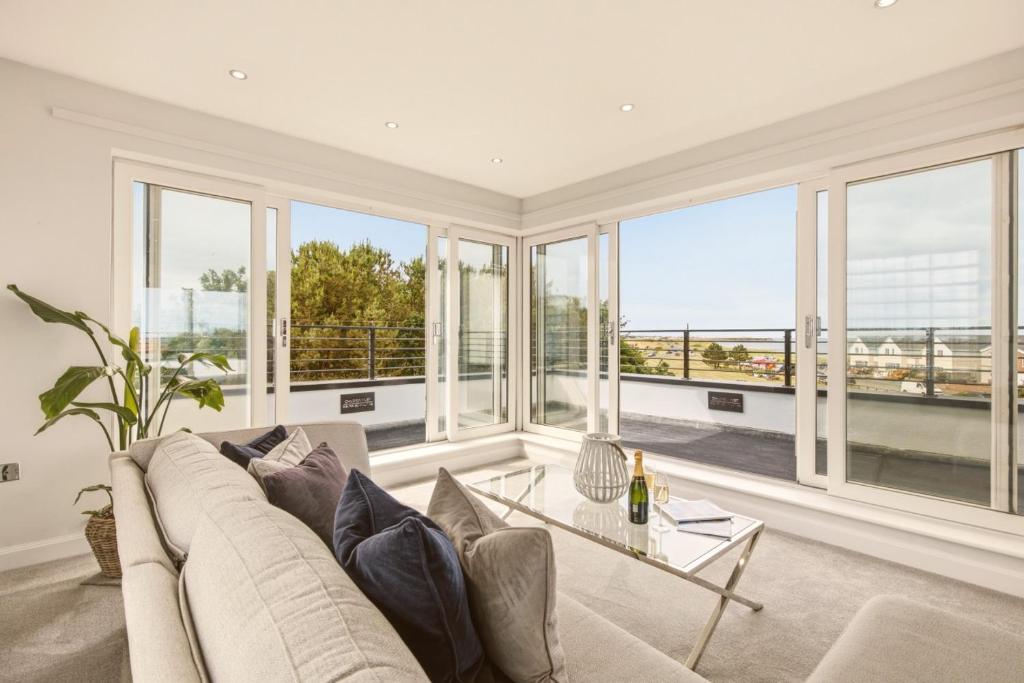 a living room with a couch and a table at Beadnell Point - North East Escapes in Beadnell