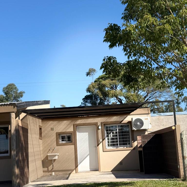 a house with a garage and a tree at Tu lugar de descanso III in Federación