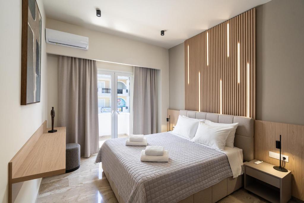 a bedroom with a bed with two towels on it at Agathe Apartment in Ierapetra