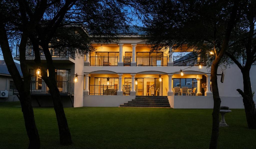 a large white house with lights on it at Le Vaal Manor in Parys