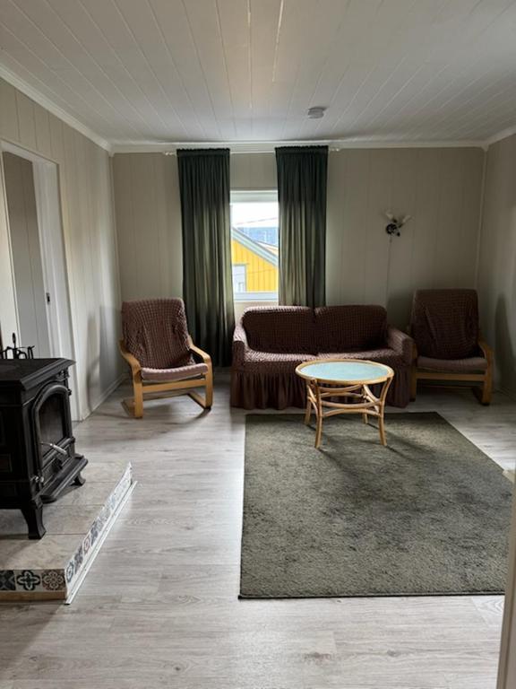 a living room with a couch and a table at Arctic View Apartament Vardø in Vardø