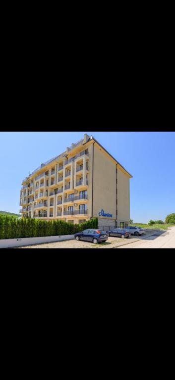 a large building with a car parked in front of it at Azur properties 22 in Shkorpilovtsi