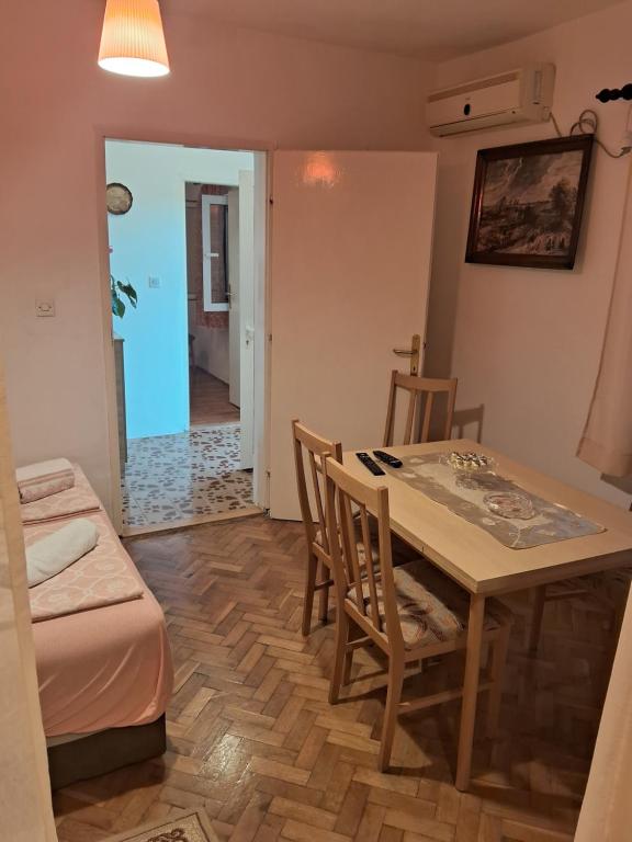 a kitchen and dining room with a table and chairs at Bosiljak in Zelenika