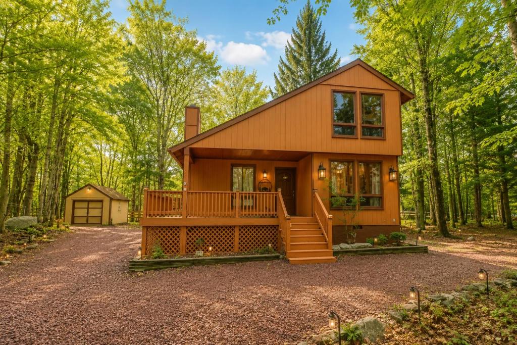 a tiny house in the woods with a driveway at Clocked Out Cabin with Lake Access, Fire Pit, Games in Blakeslee