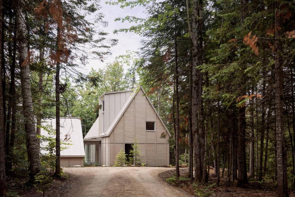 a white barn in the middle of a dirt road at The Cape in Rawdon