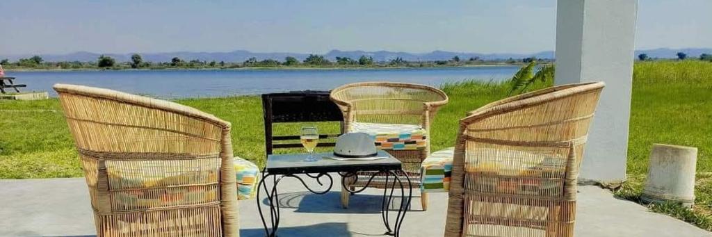 a table and two chairs with a table and a tableablish at Whispering Woods in Kafue